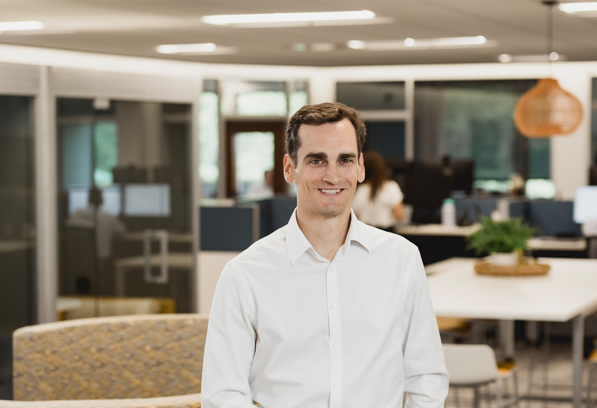 Connor Gaffney, CFP, Lead Financial Advisor: A man with white shirt in an office background. large photo.
