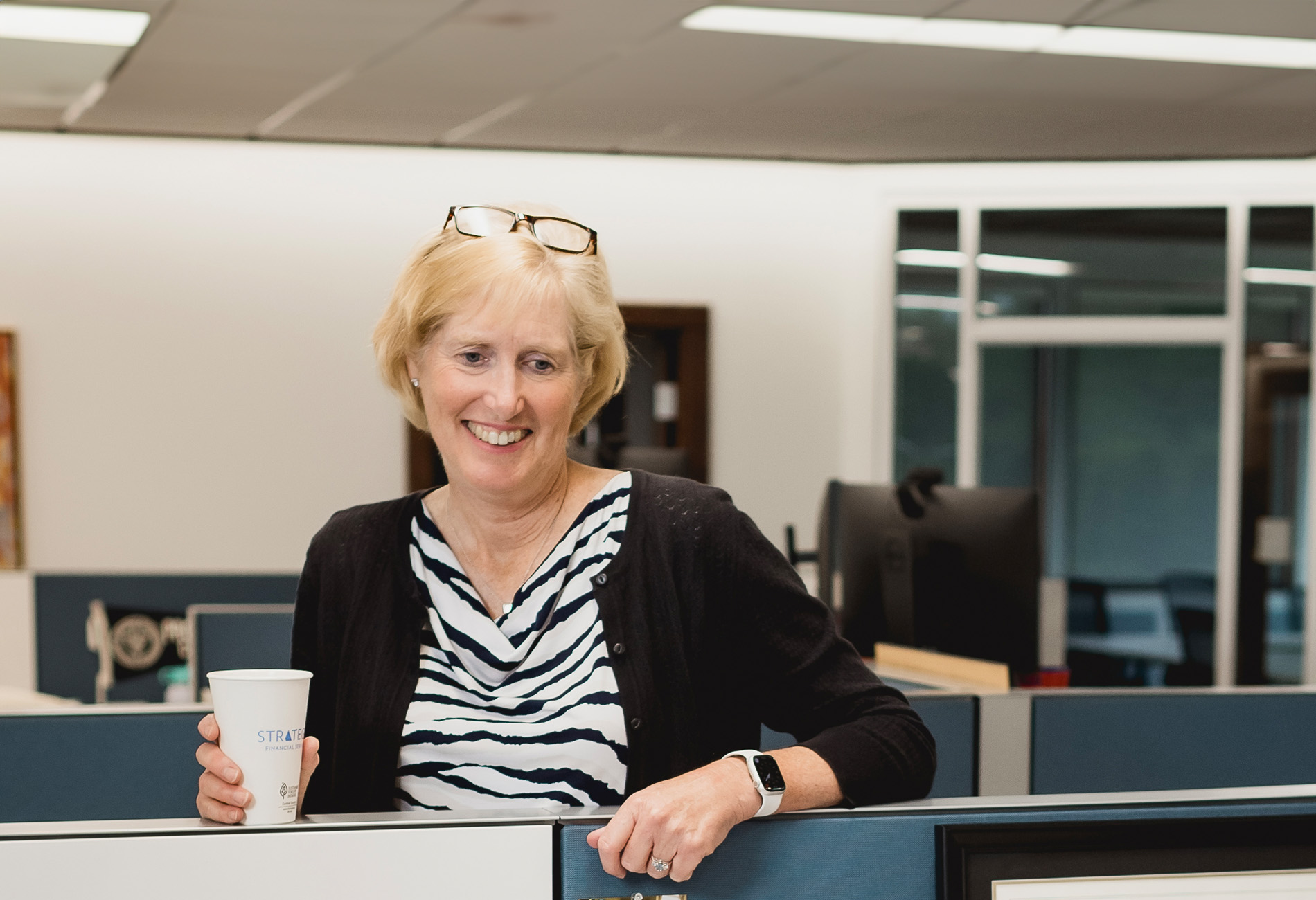 Judy Sweet CFA, Senior Financial Advisor, Female Financial Advisor, Partner: A woman with short blonde hair and glasses on her head.